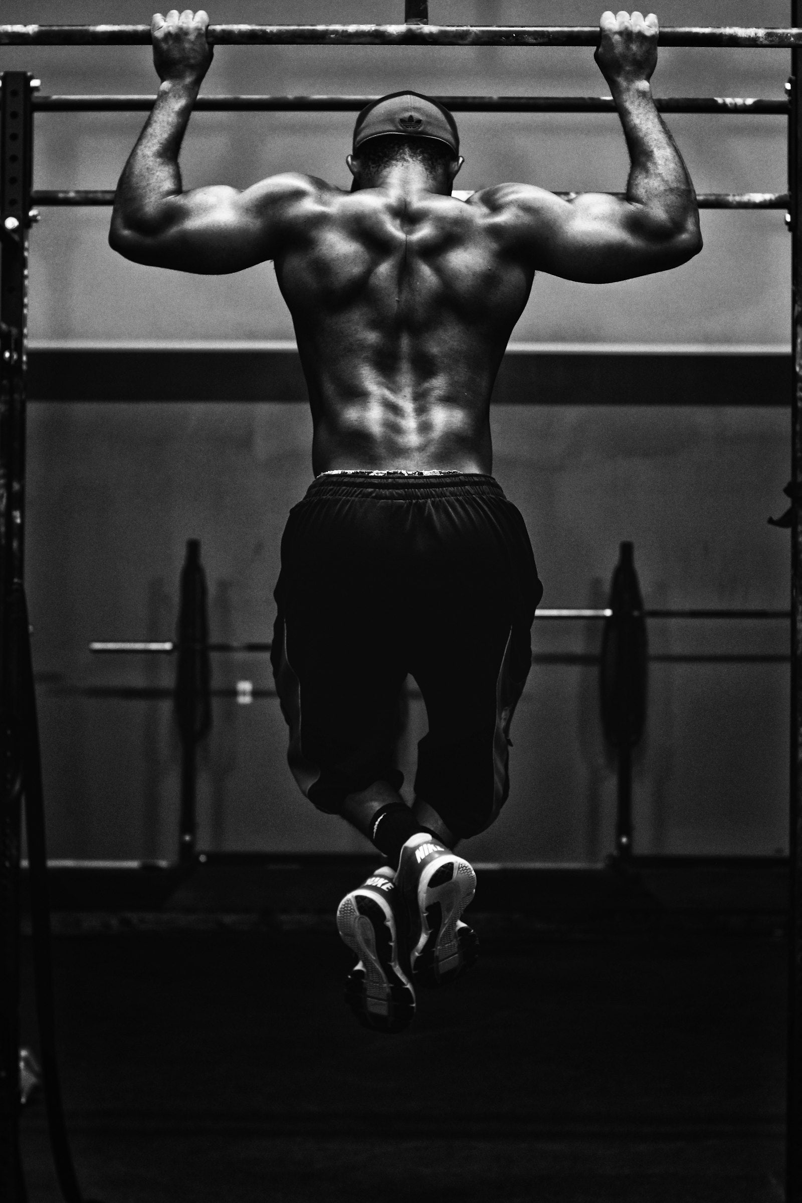 Hands gripping barbell deadlift dark floor gym
