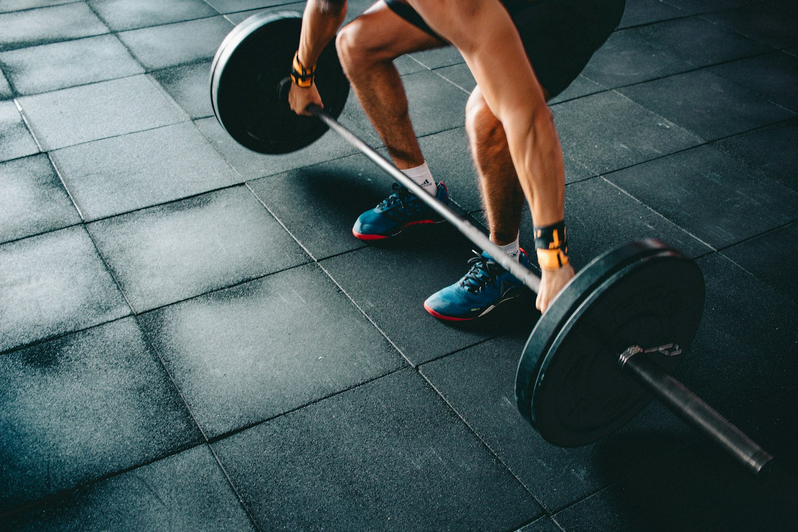 Deadlift barbell grip close up dark gym